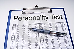 Personality Test Sheet And Pen With Clipboard Over Table