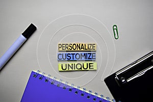 Personalize - Customize - Unique text on sticky notes with office desk concept