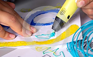 A persone drawing 3d pen that hardens in the air close-up. photo