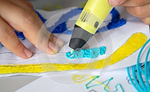 A persone drawing 3d pen that hardens in the air close-up. photo