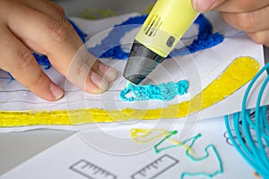 A persone drawing 3d pen that hardens in the air close-up. photo