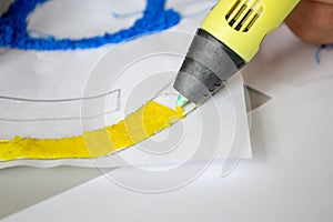 A persone drawing 3d pen that hardens in the air close-up. photo