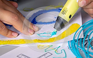 A persone drawing 3d pen that hardens in the air close-up. photo