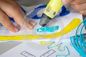 A persone drawing 3d pen that hardens in the air close-up. photo