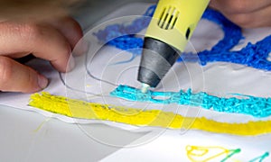 A persone drawing 3d pen that hardens in the air close-up. photo