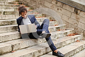 Personnel consultant chatting with client by laptop on steps.