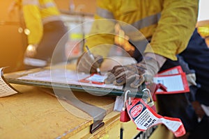 Personnel red danger locks attached with danger tags are locking on safety isolation permit lock box