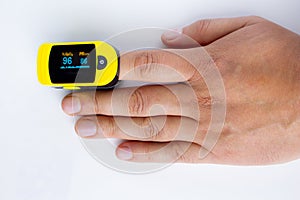 A persons hand palm using a pulse oximetry, noninvasive method for monitoring people`s oxygen saturation