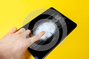 persons hand touch screen of a gadget to scan a finger print n