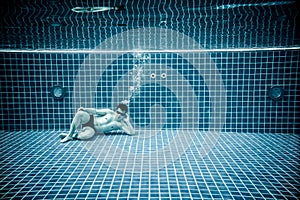 Persons lies under water in a swimming pool photo