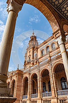 Perspective of blurred column with arch framing palace tower in Plaza de EspaÃ±a, Seville SPAIN photo