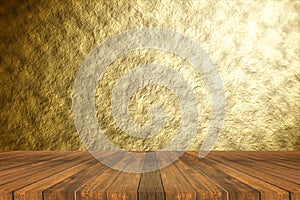 Perspective brown wooden floor against Abstract gold texture background with beautiful spotlight emit effect.