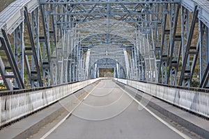 Perspective center angle view at the bridge in metallic truss structure over Douro River in Pinhao city, asphalt road