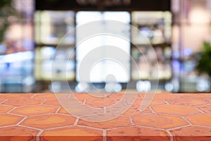 Perspective empty mon brick flooring clay brick over blurred shopping mall background, for product display montage or design