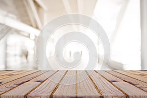 Perspective empty wooden table on top over blur background, can