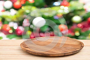 Perspective empty wooden tray table and christmas tree blur decoration background, for product display montage or design layout.
