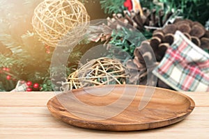 Perspective empty wooden tray table and christmas tree blur decoration background, for product display montage or design layout