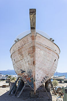 Perspective front shot of fishing boat on ground for painting of trunk at Lesvos, Kalloni