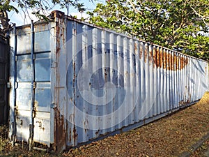 Perspective of old rusty container. Old rusty blue shipping container for logistics and transportation