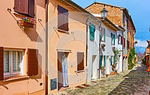 Perspective of an old street with colorful houses italian town