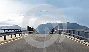 Perspective of road bridge against mountains