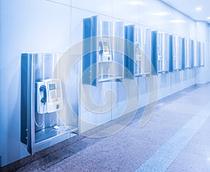 Perspective row of public telephone inside modern building