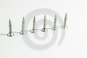 Perspective shoot of diagonal positioned multiple screws on white background