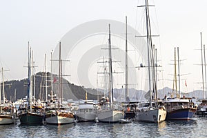 Perspective shoot of wooden sailing yacht near shore at sunset time