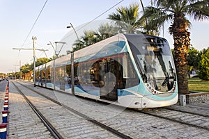 Perspective shot of tramway in movement with pedestrian stones at sunset time in Izmir at Turkey