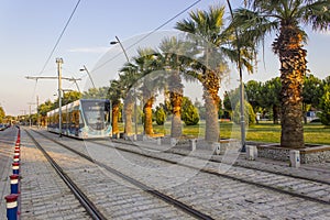 Perspective shot of tramway with pedestrian stones at sunset time in Izmir at Turkey