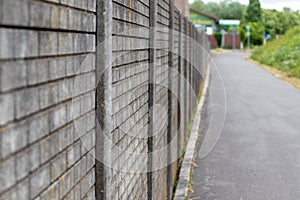 perspective on a stone wall and a pedastrian and cycle way