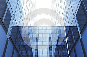 Perspective and underside angle view to textured background of modern glass blue building skyscrapers. Horizontal mockup