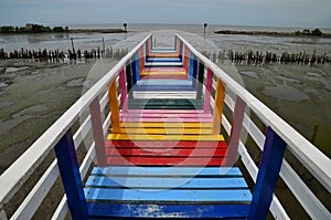 Perspective view of the beautiful colorful rainbow wooden bridge in Samut Sonkram Province, Thailand