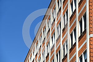 Perspective view from below of  building facade under blue sky