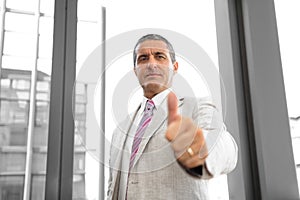 Perspective view of a business man with thumbs up