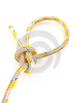 Perspective view of cape with isolated sailor knot. Knot tied in rope on white background. Close up of Loop knot. Navigation and