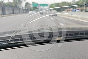 Perspective view of cracked car windscreen or windshield while d