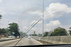 Perspective view of cracked car windscreen or windshield while d