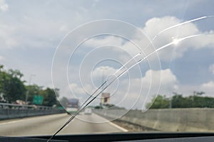 Perspective view of cracked car windscreen or windshield while d