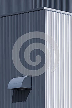 Perspective view of dryer vent on white and grey corrugated metal warehouse building