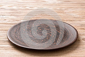 Perspective view of empty plate on wooden background. Empty space for your design