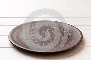 Perspective view of empty plate on wooden background. Empty space for your design