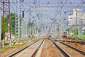 Perspective view on empty railway tracks for high speed trains and suburban trains and electric infrastructure equipment, devices.