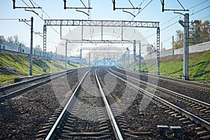 Perspective view on empty railway tracks for high speed trains and suburban trains and electric infrastructure equipment, wires, d