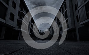 Perspective view of empty road between residential building with dark clouds and sky in the city. No people on urban street. Real