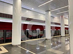 Perspective view of High speed train with opened automatic doors at the platform railway station without people