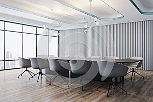 Perspective view on huge empty dark meeting table surrounded by modern chair in conference room with minimalistic interior and