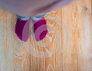 Perspective view of a kid`s feet with purple socks