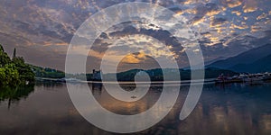 Perspective view of lake scenery at sunrise. Shrouded in mist cloud, exchanging light and shadow form a scenic scene. photo