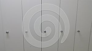 Perspective view of lockers or cupboards in a row with white doors